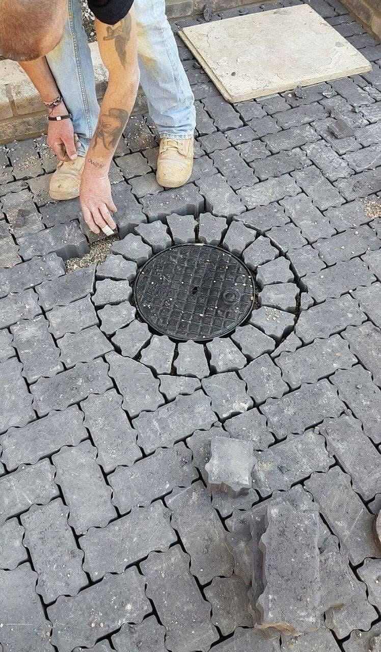 Block paving detail work around manhole cover